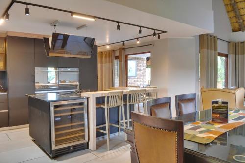 a kitchen with a counter and a bar with chairs at Kruger Park Lodge Unit 268 & Unit 531 in Hazyview