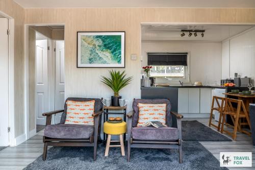 a living room with two chairs and a table at Lakeside Lodge in Caernarfon