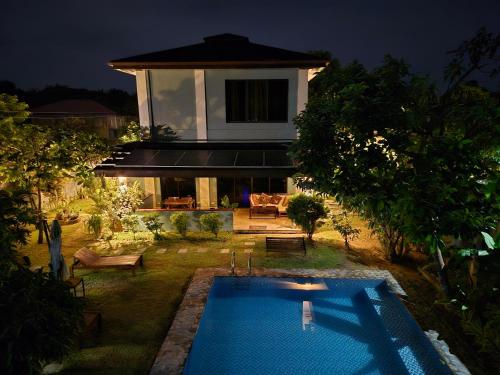 a house with a swimming pool in the yard at Anahaw in El Nido