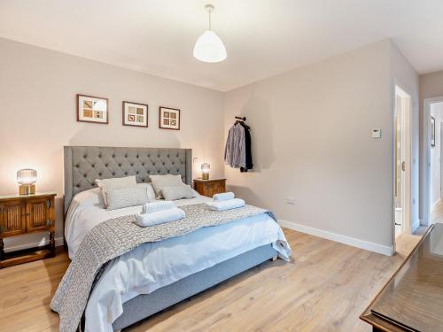 a bedroom with a large bed with two pillows at 4 Bed in Newmachar 93914 in Dyce