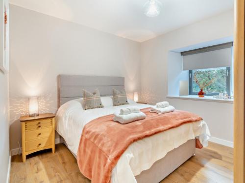 a bedroom with a large bed and a window at 4 Bed in Newmachar 93914 in Dyce
