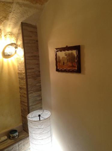 a room with a lamp and a painting on the wall at Sea Home 1 in Monopoli