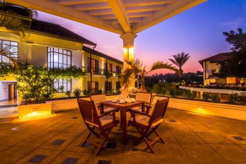 a patio with a table and chairs on a house at Mahaweli Reach Hotel in Kandy