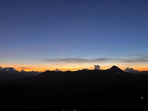 a sunset over the mountains with the sky at Hotel Hostal El Castillo Santa in Santa Bárbara