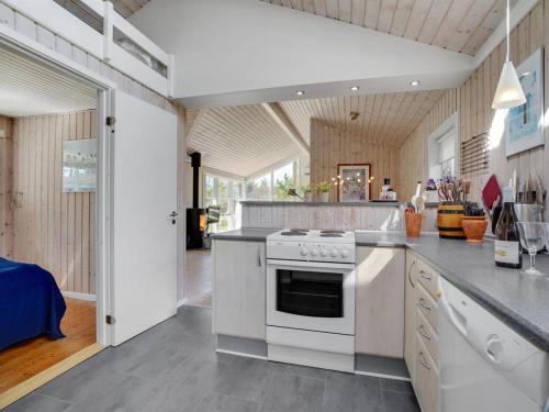 a kitchen with a white stove top oven at Holiday Home Herwarth - 3-3km from the sea by Interhome in Blokhus