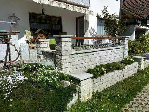 a brick retaining wall in front of a house at Komfort trifft Natur in Albbruck