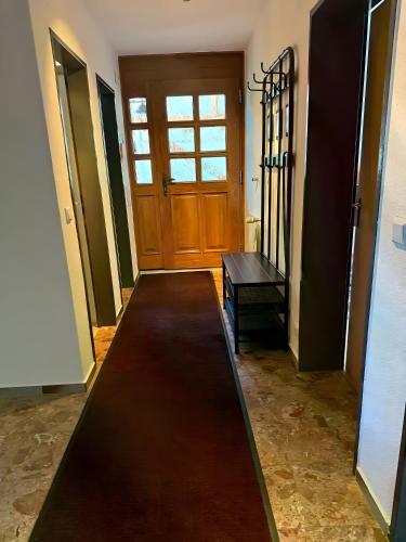a hallway with a wooden door and a table at Komfort trifft Natur in Albbruck