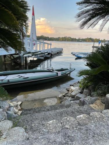 a dock with two boats on the water at Palms in Paradise 2 Docks & Steps into Lake Murray in Chapin