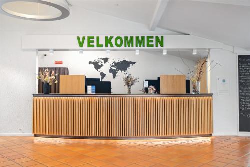 a lobby with a desk with a welcome sign at Best Western Hotel Hillerød in Hillerød
