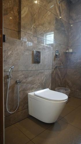 a bathroom with a toilet and a shower at Tree Blanche Resort Munnar in Anachal