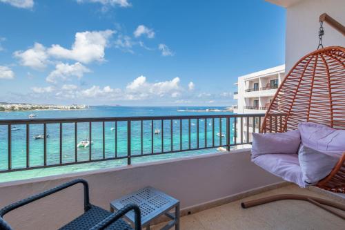 a balcony with chairs and a view of the ocean at NYX Hotel Ibiza by Leonardo Hotels-Adults Only in San Antonio Bay