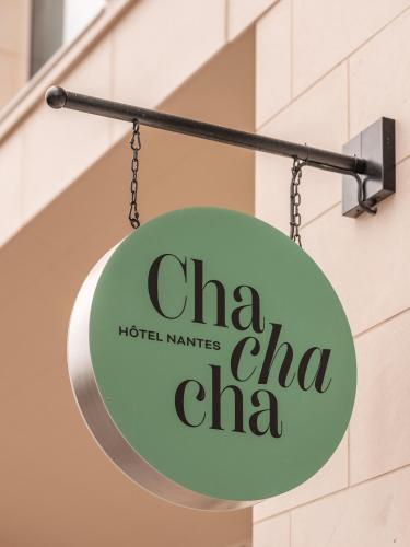 a sign for a hotel market china hangs on a building at Chachacha Hôtel in Nantes