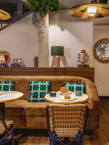 a dining room with a table and chairs at Chachacha Hôtel in Nantes