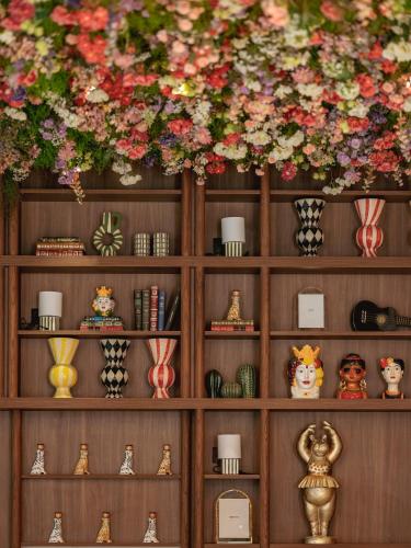 a wooden shelf with vases and flowers on it at Chachacha Hôtel in Nantes