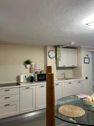 a kitchen with a table and a clock on the wall at Villa Luce in Vairano