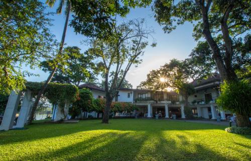 an exterior view of a house with a yard at Mahaweli Reach Hotel in Kandy