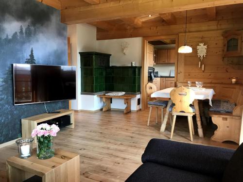 a living room with a television and a dining room at Urbanshof Herr Tobias Fehrenbach in Hinterzarten