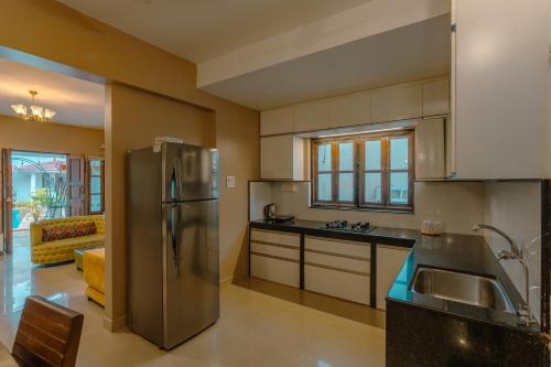 a large kitchen with a stainless steel refrigerator at 2 bedroom perfect stay villas in Anjuna