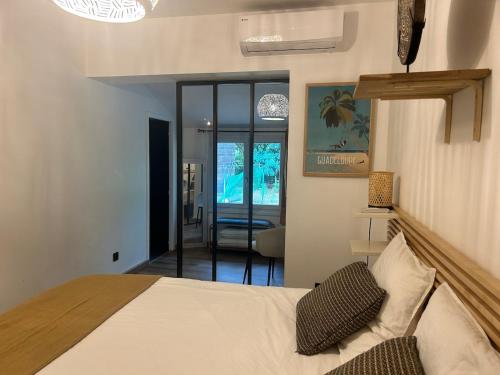 a bedroom with a bed and a living room at la villa in Lacanau