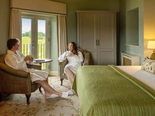 a man and woman sitting in a hotel room at Lough Erne Resort in Enniskillen