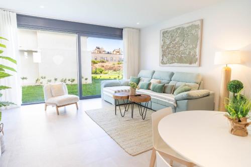 a living room with a couch and a table at Tarifa Cozy House - Casa Verde Agua in Tarifa