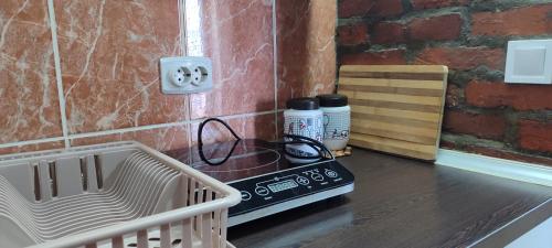 a stove top oven sitting on a counter in a kitchen at Apartmani Mali Raj Rudnik in Rudnik Kačerski