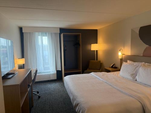 a hotel room with a bed and a desk at Spark by Hilton Kimball in Kimball