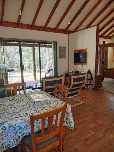 a dining room with a table and chairs and a television at Yelverton Brook Conservation Sanctuary in Metricup