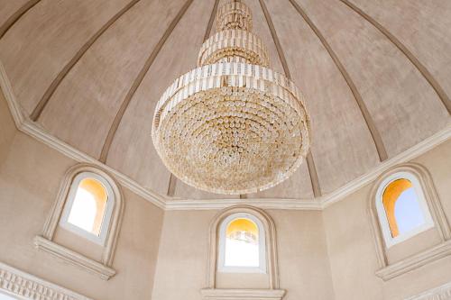 a chandelier hanging from the ceiling of a building at One bedroom apartment A 401 by Peaks Palm Beach Piazza Sahl Hasheesh in Banī Ghālib