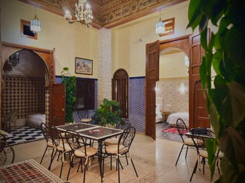 a dining room with a table and chairs in a room at Riad Shama in Rabat