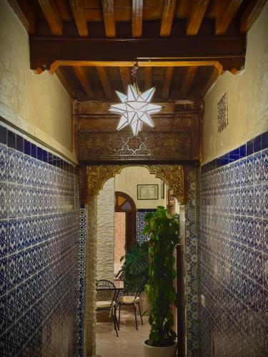 a hallway with a star light hanging from a wall at Riad Shama in Rabat