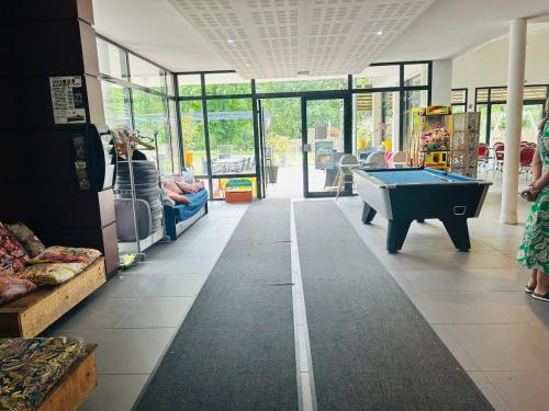 a store with a pool table in the middle of a room at Villa haut de gamme 11 personnes jacuzzi privé in Lacanau