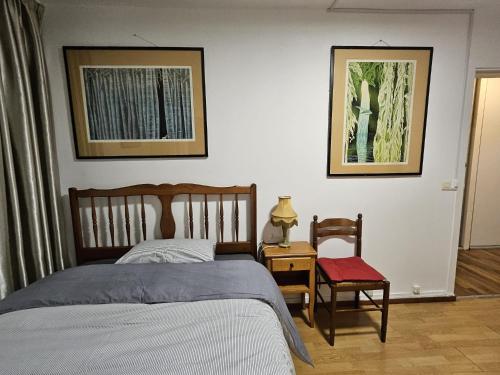 a bedroom with a bed and a table and a chair at A Paris in Paris