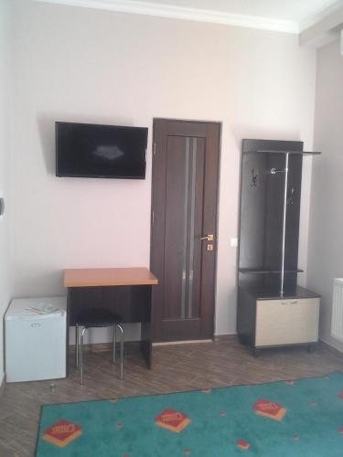 a room with a desk and a tv on the wall at City Club European in Chernivtsi