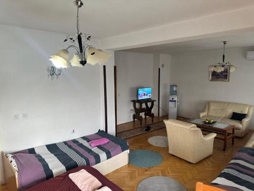 a living room with a bed and a couch at Apartman Struga in Struga