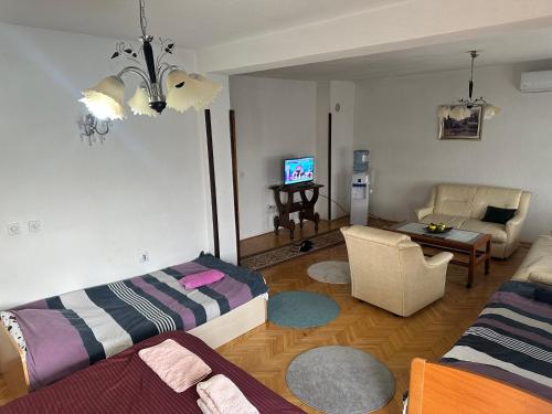 a living room with a couch and a tv in it at Apartman Struga in Struga