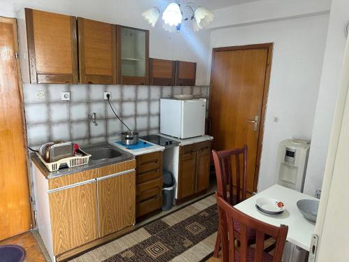 a small kitchen with a sink and a refrigerator at Apartman Struga in Struga