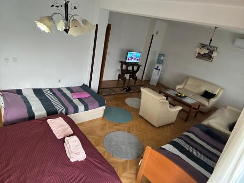 a living room with two beds and a couch at Apartman Struga in Struga