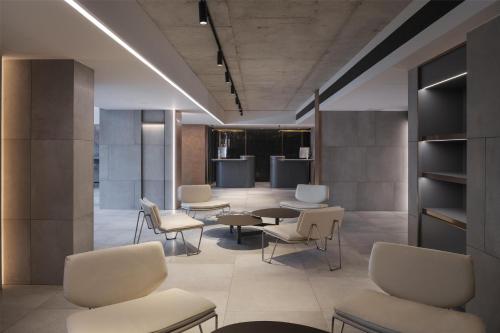 a waiting room with chairs and a table at Radisson Hotel Don Mueang Bangkok in Bangkok