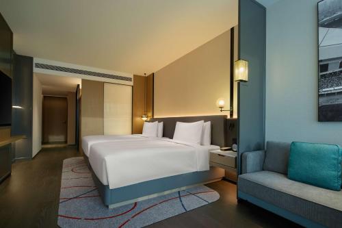 Ένα ή περισσότερα κρεβάτια σε δωμάτιο στο Radisson Blu Hotel, Shanghai Stadium