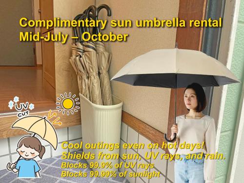 a woman is holding an umbrella in a picture at Senjushuku FUJI 101 北千住 in Tokyo