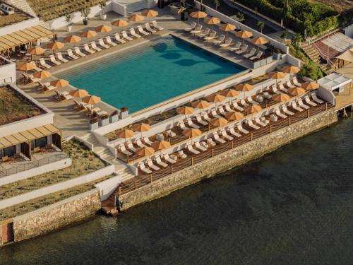 an overhead view of a pool with umbrellas and water at Cabo in Kavos
