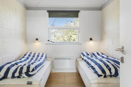 a living room with two couches and a window at LN1953-Hirtshals-Klinken-26 in Hirtshals