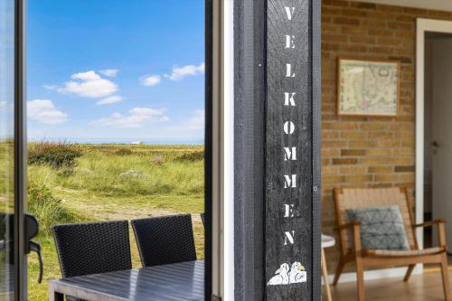 a table and a window with a view of the ocean at LN1953-Hirtshals-Klinken-26 in Hirtshals