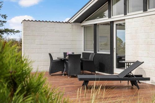 a patio with chairs and a table on a house at LN1953-Hirtshals-Klinken-26 in Hirtshals