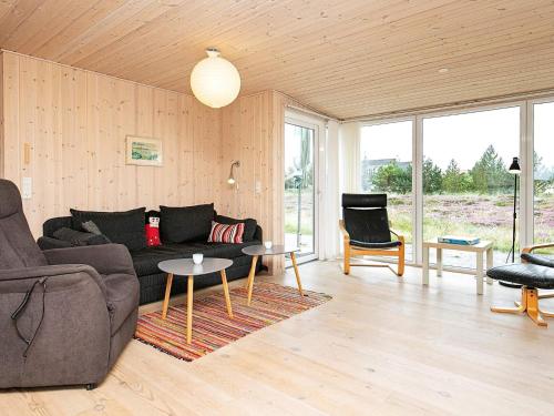 a living room with a couch and a table at Cozy Coastal Retreat in Vorupor-By Traum in Thisted
