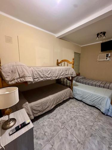 a room with two bunk beds and a table at Hotel Interlagos in San Juan