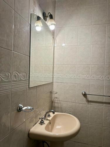 a bathroom with a sink and a mirror at Hotel Interlagos in San Juan