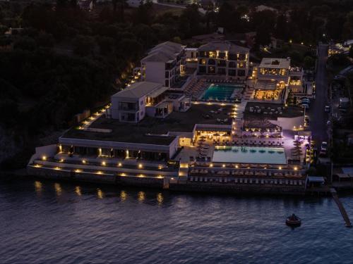 an aerial view of a mansion on the water at night at Cabo in Kavos