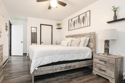 a bedroom with a large bed and a dresser at Cheerful Hot Springs Village Condo in Hot Springs